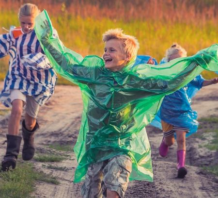 Manners Matter: How To Instill Good Etiquette In Your Kids kids running colourful rain coast
